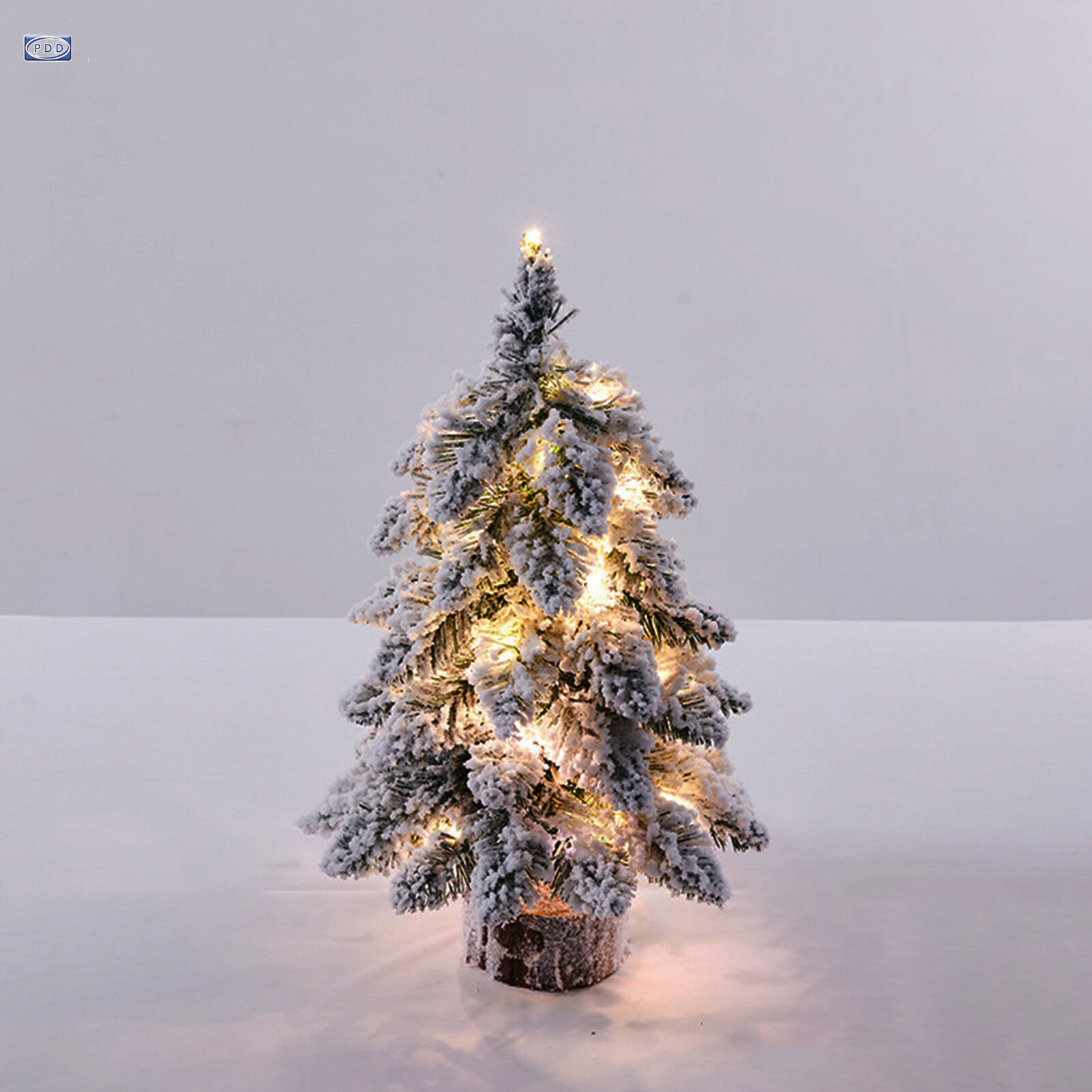 small flocked christmas tree with lights